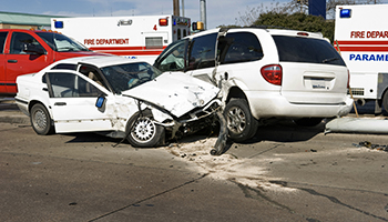 A white car is depicted in the midst of a collision